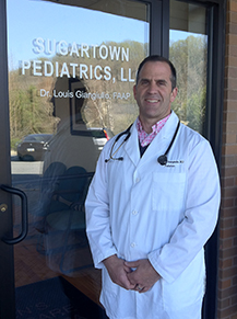 Dr. Giangiulio in front of his Sugartown Pediatrics office